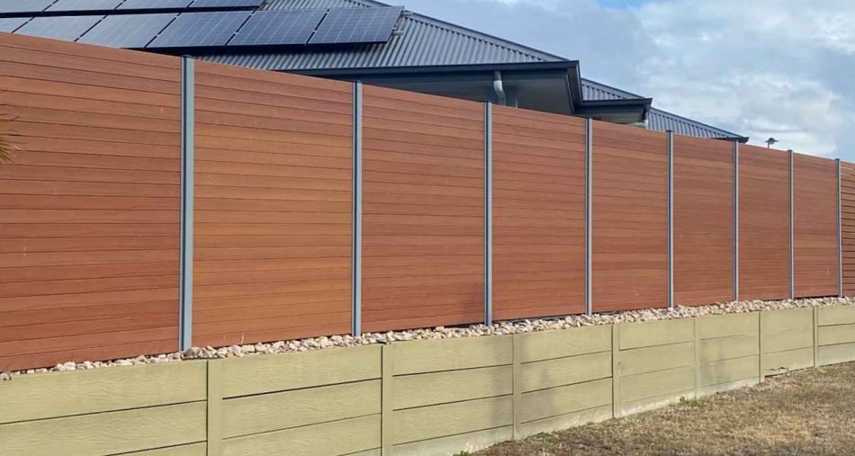 Treated Pine Fence on top of Treated Pine Sleepers Retaining Wall. Timber available from Tradeware Building Supplies Brisbane